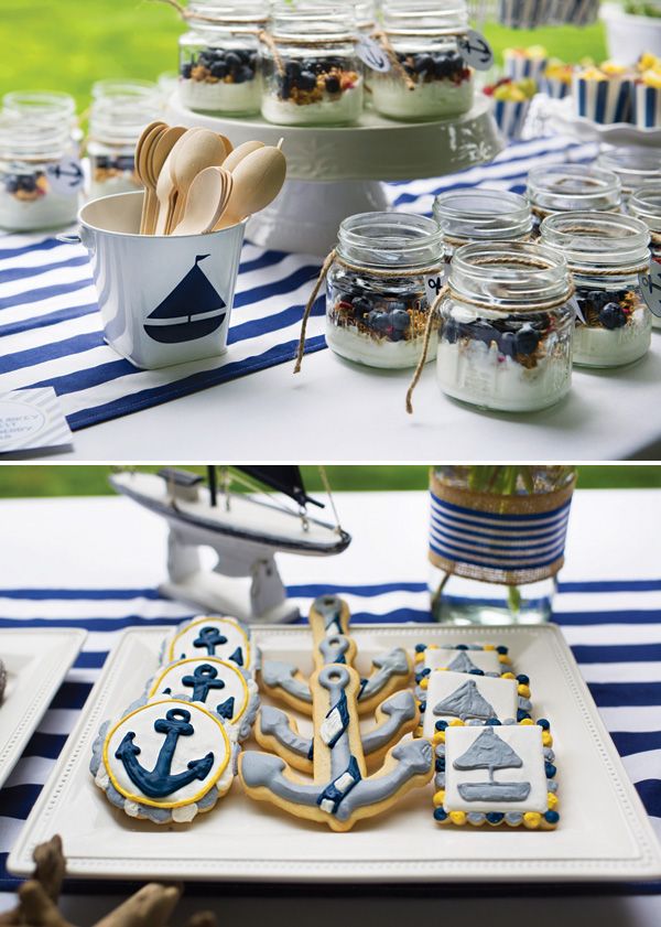 desserts and cookies are displayed in glass jars on a table with blue striped cloth