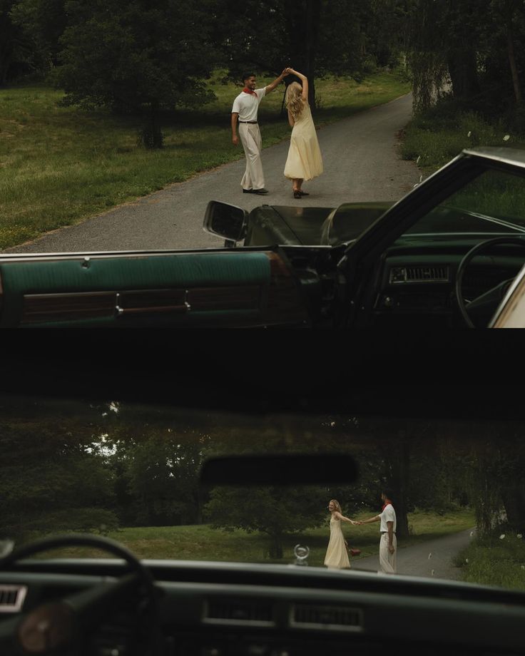 two people standing next to a car on a road