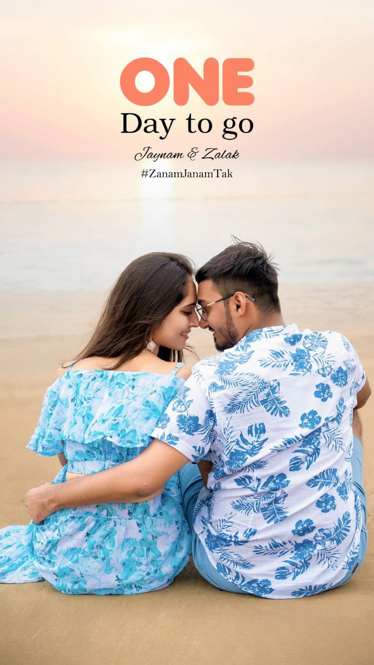 a man and woman sitting on the beach with their arms around each other as they look into each others eyes