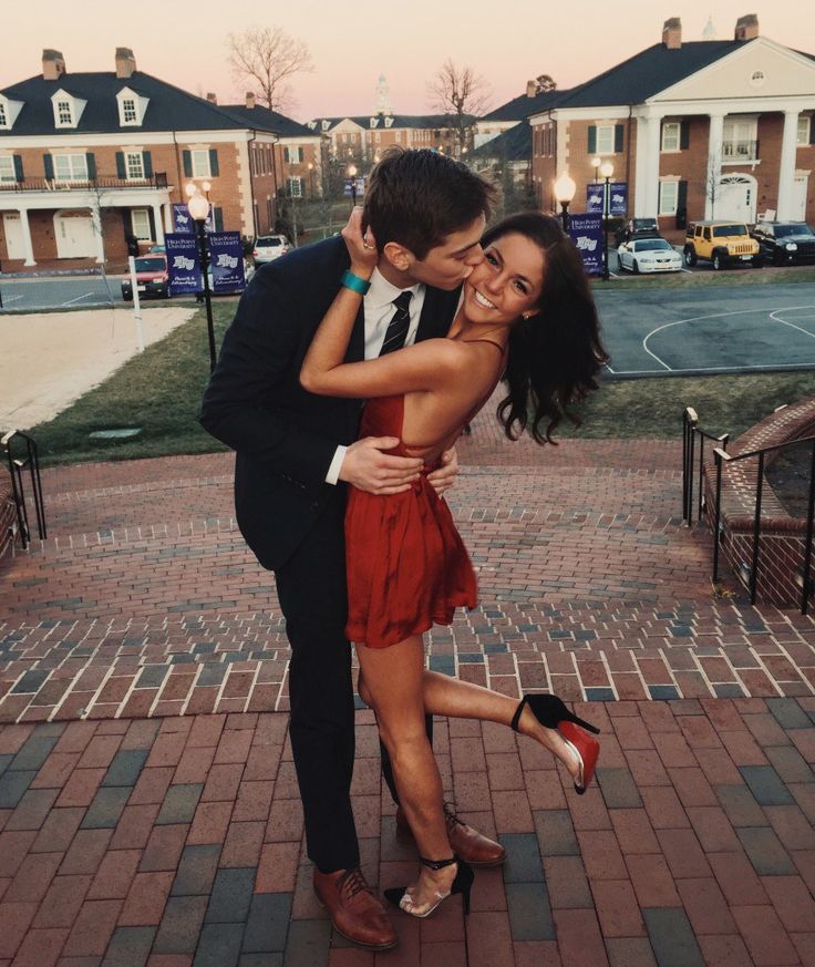 a man in a suit and tie hugging a woman