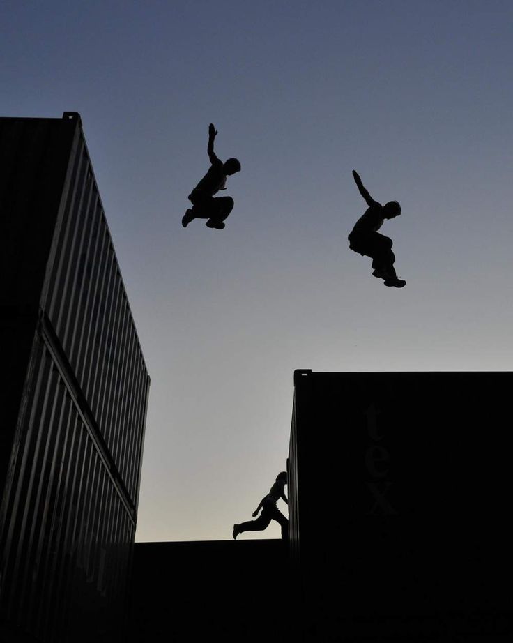 two skateboarders are doing tricks in the air