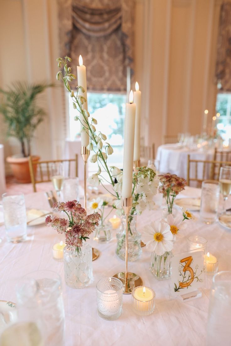 the table is set with candles and flowers