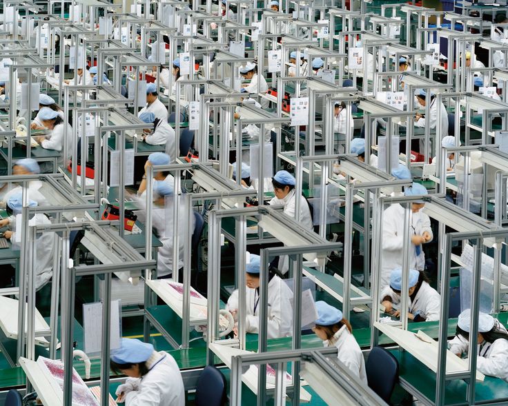 workers are working in an assembly line at a factory