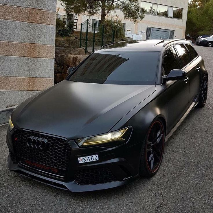 a black car parked in front of a building