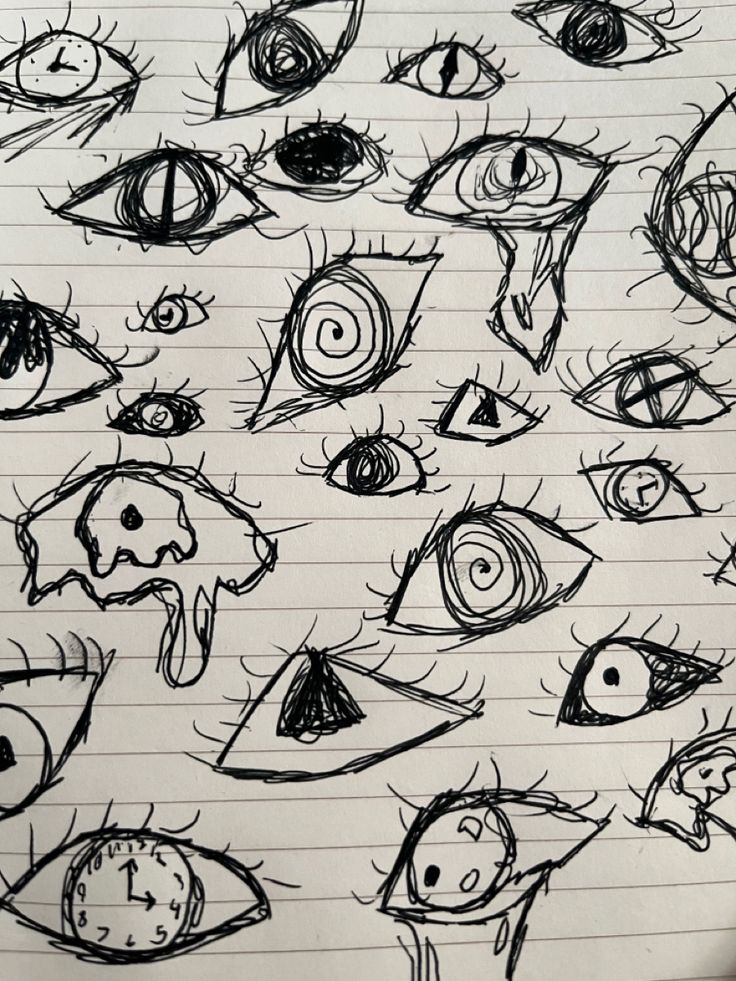 a bunch of different types of eyes drawn in pencil on lined paper with pen and ink