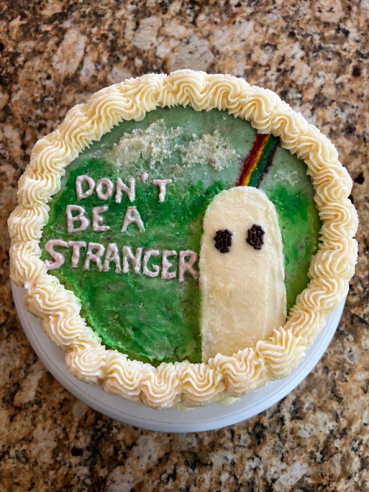 a cake decorated to look like a ghost with the words don't be a stranger on it