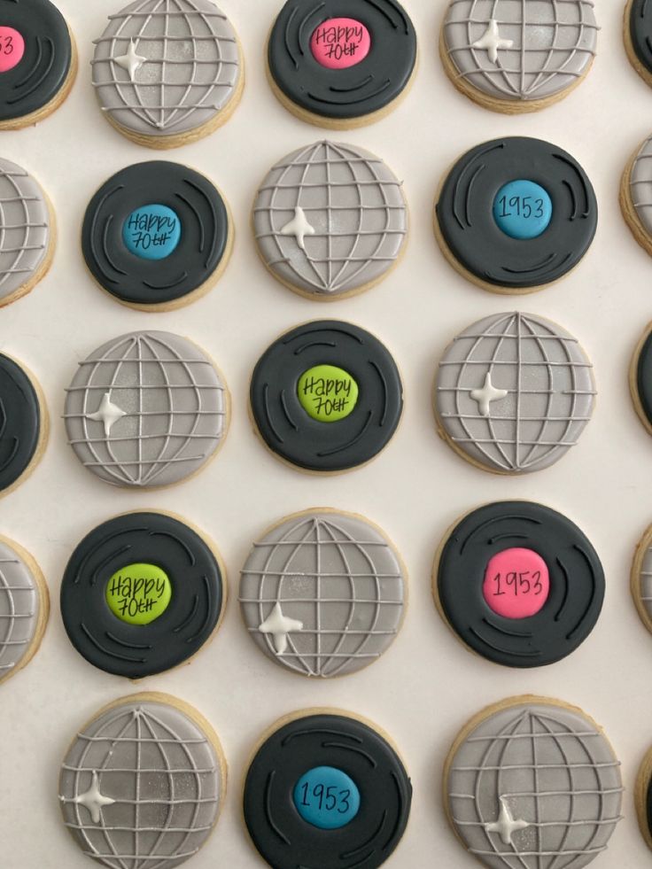 decorated cookies are arranged on a white surface