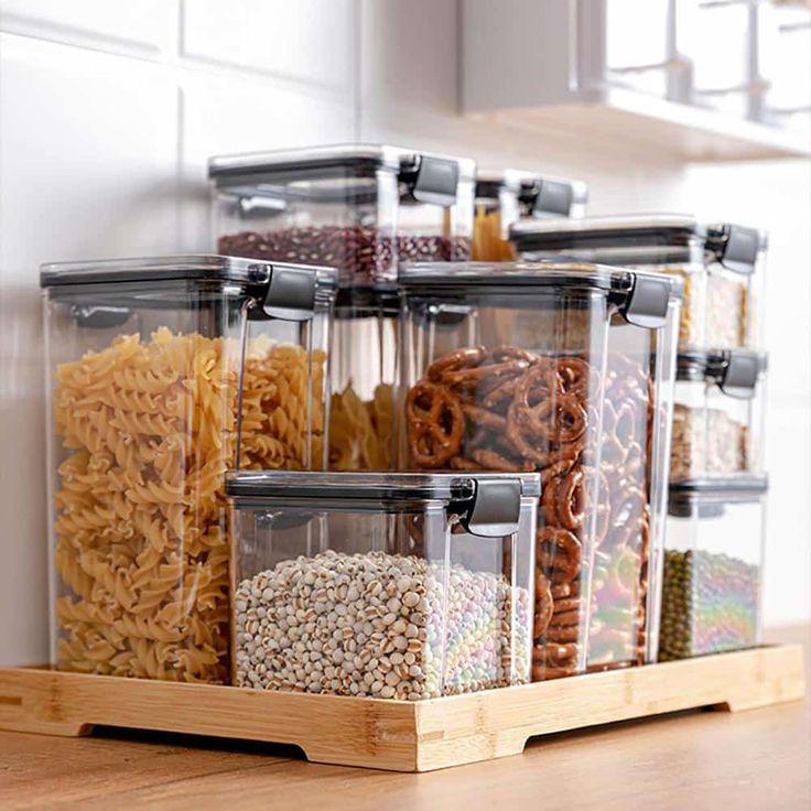 several containers with cereal and pretzels in them