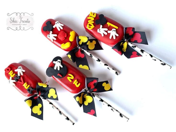 four decorated candy sticks with mickey mouse designs on them and the words i love you written on them