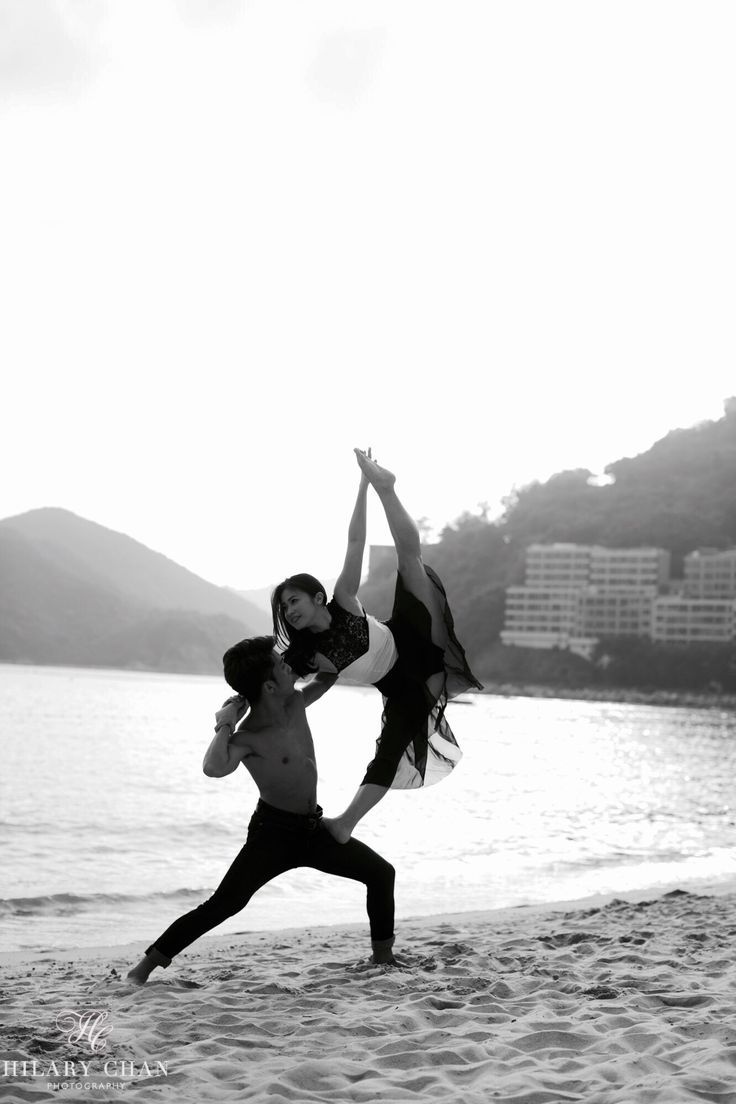 two people are doing yoga on the beach