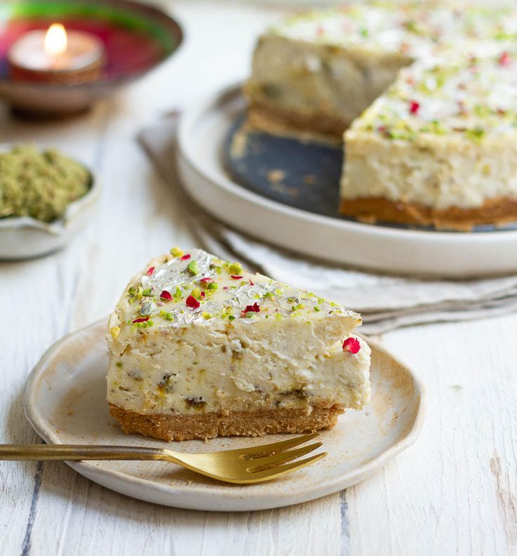 a piece of cake on a plate with a fork next to it and another slice in the background