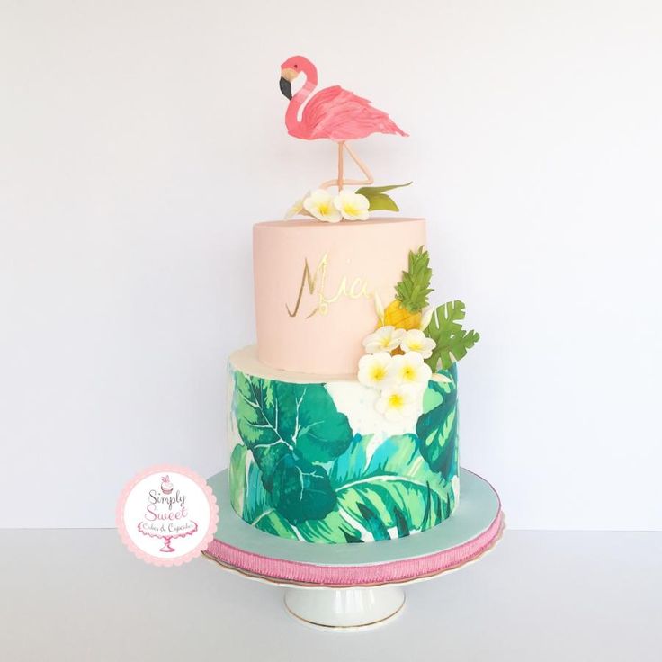 a pink and green cake with a flamingo on top