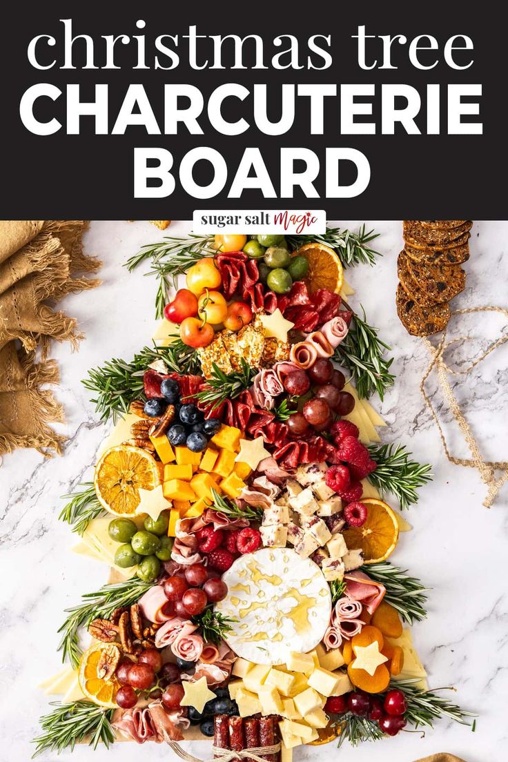 a christmas tree made out of cheese and fruit on a marble counter top with text overlay that reads christmas tree charcuterie board