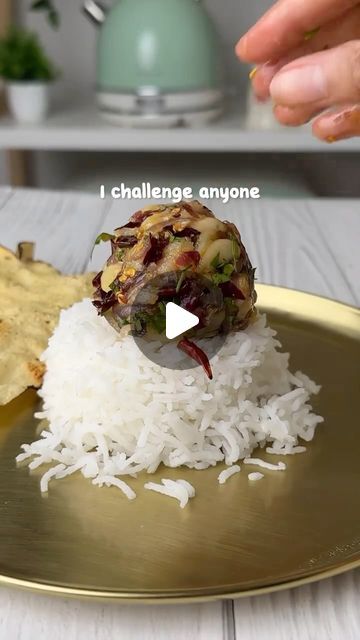 a plate with rice, meat and vegetables on it that is being served to someone