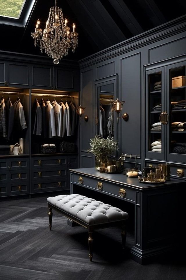 an elegant walk in closet with black walls and gold trimmings, chandelier,