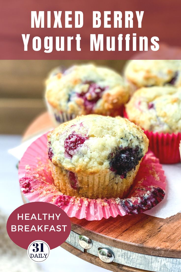 blueberry muffins on a pink plate with text overlay that reads mixed berry yogurt muffins healthy breakfast