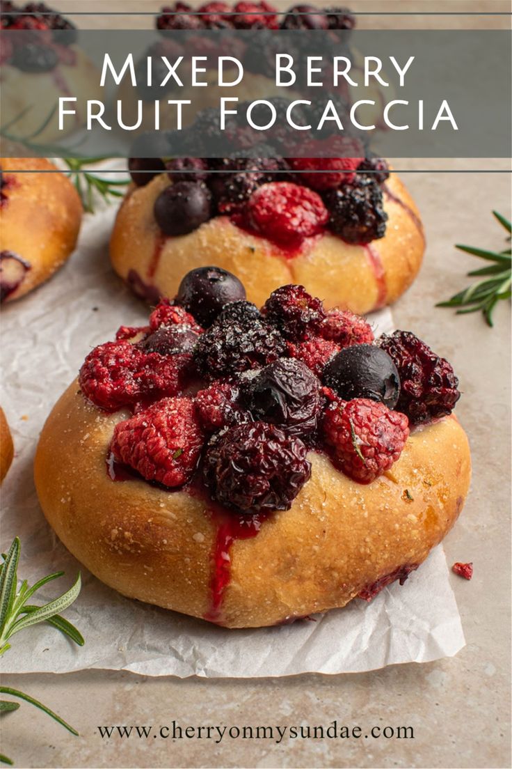 fresh berries and blueberries are on top of bread