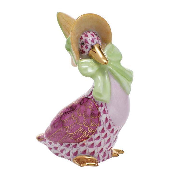 a glass figurine with a hat on it's head and purple dress