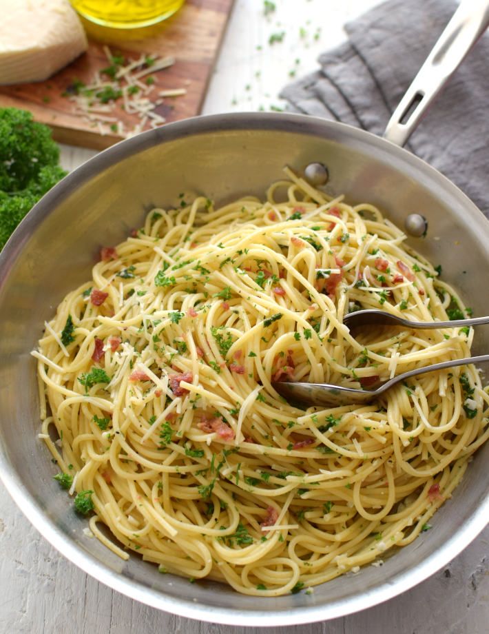 a bowl filled with pasta and garnished with parsley