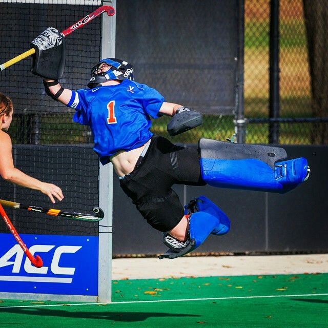 a person jumping in the air with a hockey stick