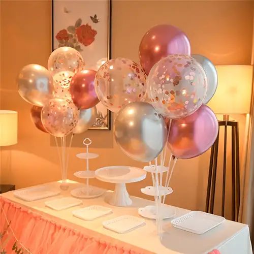 a table topped with lots of balloons and plates