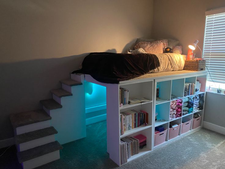 a bed with bookshelves and stairs in a room