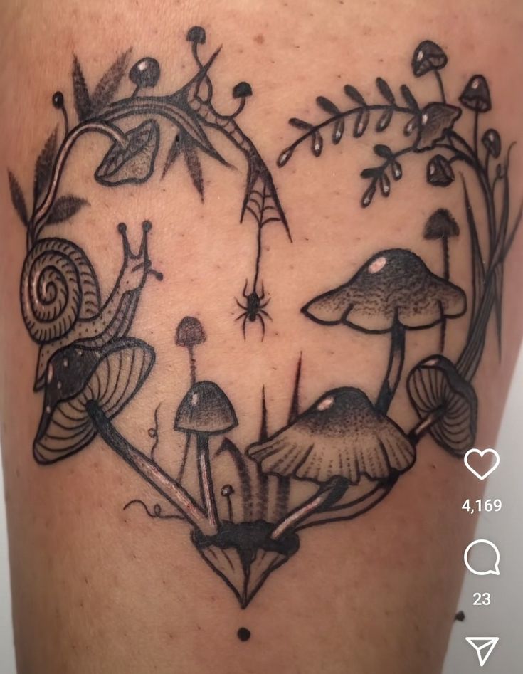 a heart shaped tattoo with mushrooms and leaves