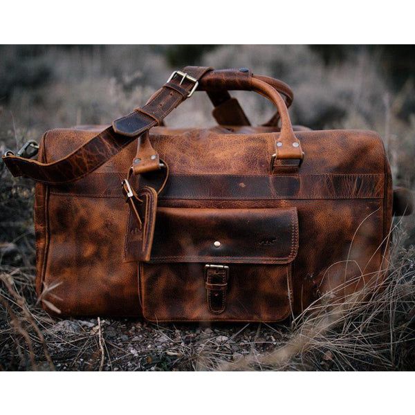 The Buffalo Leather Duffle Bag This classic men's buffalo leather duffel bag is the ultimate weekend escape companion. Whether it's a few days camping with the guys or a romantic weekend with a loved one, this buffalo leather weekender is designed to hold all the gear you need yet still show off your classic, rugged style. Perfect for the refined, timeless man, this buffalo leather duffel bag has all the functionality and durability you would expect from a bag that is designed to last a lifetime Brown Leather Luggage For Overnight Trips, Brown Leather Lined Duffle Bag For Weekend Trips, Brown Leather-lined Duffle Bag For Weekend Trips, Brown Leather Lining Duffle Bag For Weekend Trips, Classic Weekender Bag For Overnight Trips With Waxed Finish, Classic Waxed Weekender Bag For Overnight Trips, Leather Duffle Bag With Luggage Sleeve For Weekend Trips, Brown Leather Lined Duffle Bag For Trip, Brown Duffle Bag With Leather Lining For Trip