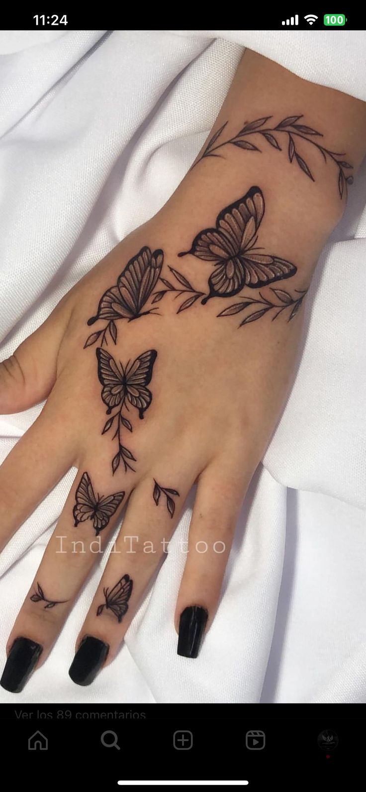 a woman's hand with butterflies on it