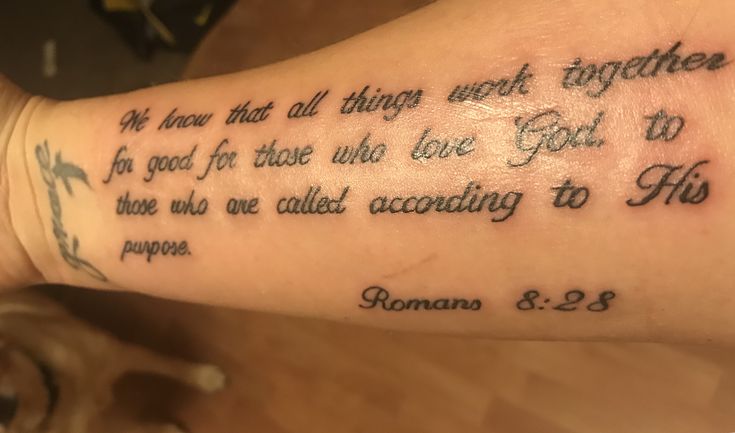 a woman's foot with a bible verse tattooed on the side of her leg