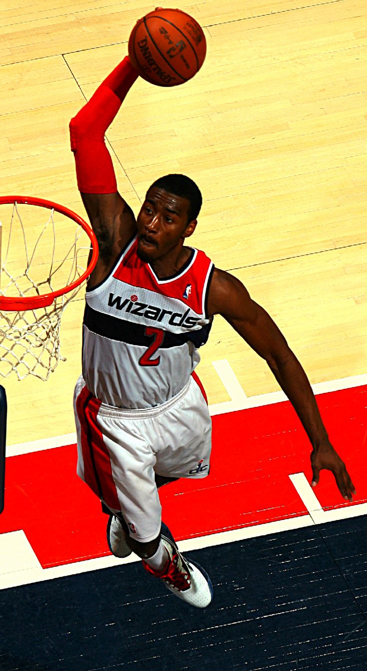 a basketball player is jumping up to dunk the ball