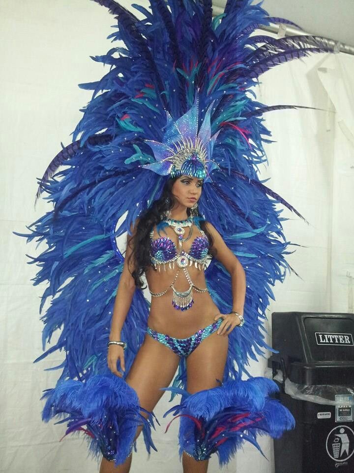 a woman in a blue feathered costume