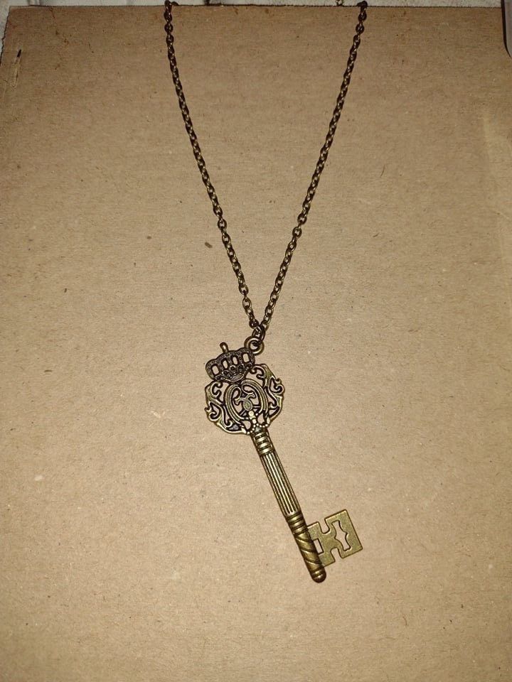 Antique bronzed skeleton key hanging from an antique bronze, 20 inch chain. Bronze Brass Necklace With Keys, Vintage Brass Necklaces With Two Keys, Antique Gold Necklaces With Two Keys, Gold Brass Necklace With Keys, Skeleton Key Necklace, Charleston Wv, Skeleton Key, Key Necklace, Chain Styles