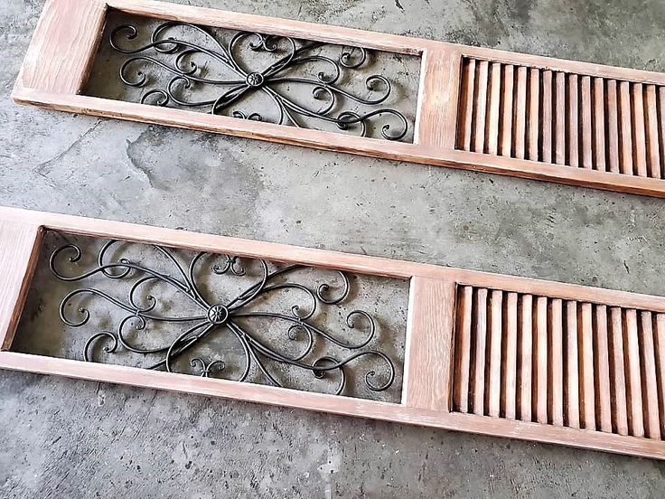 two wooden floor grates sitting on top of a cement floor next to each other