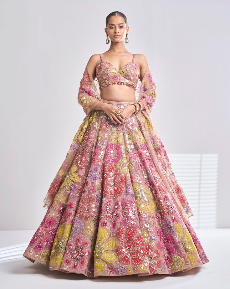 This coffee net lehenga features bright floral applique motifs along with the sprinkling of sequin and crystals. The strappy blouse and dupatta are full embroidered. From Seema Gujral’s Samode collectionDELIVERY TIMEPlease wait 8-12 weeks for your outfit to arrive.FABRIC DETAILSNetProfessional cleaning only. Strappy Blouse, Seema Gujral, Floral Lehenga, Outfits Indian, Net Lehenga, Red Lehenga, Embroidered Lehenga, Party Wear Indian Dresses, Chaniya Choli