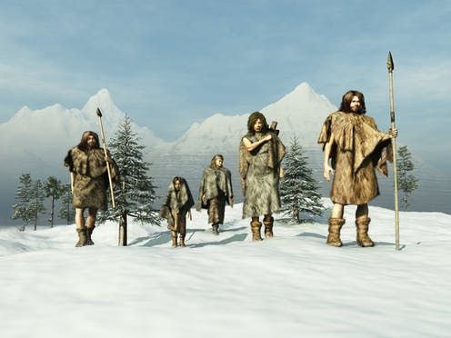 several people in fur coats walking through the snow