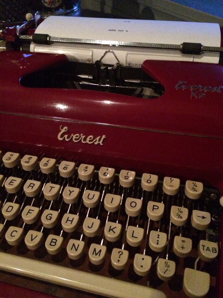 an old fashioned typewriter sitting on top of a table