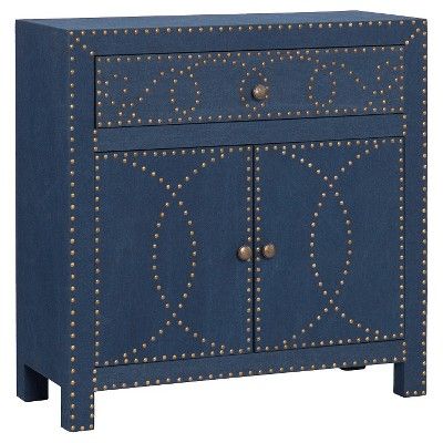 a blue cabinet with gold rivets on the front and bottom, along with two drawers