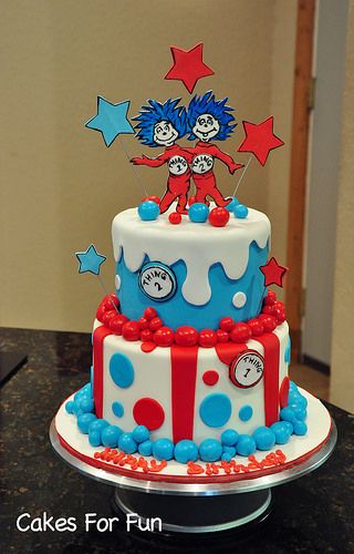 there is a cake decorated with the cat in the hat and dr seuss on top