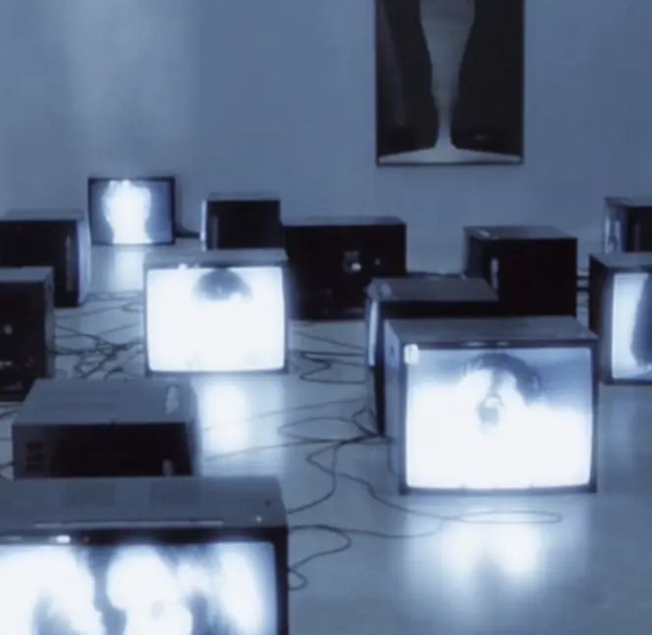 a room filled with lots of tvs sitting on top of floor next to each other