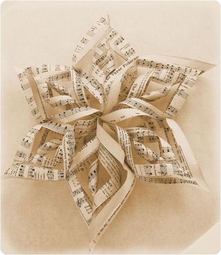 an origami flower made out of sheet music