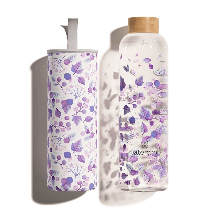 the bottle is next to the container with it's lid open and has purple flowers on it