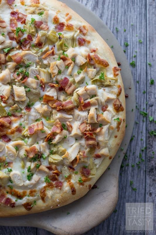 a pizza sitting on top of a wooden table