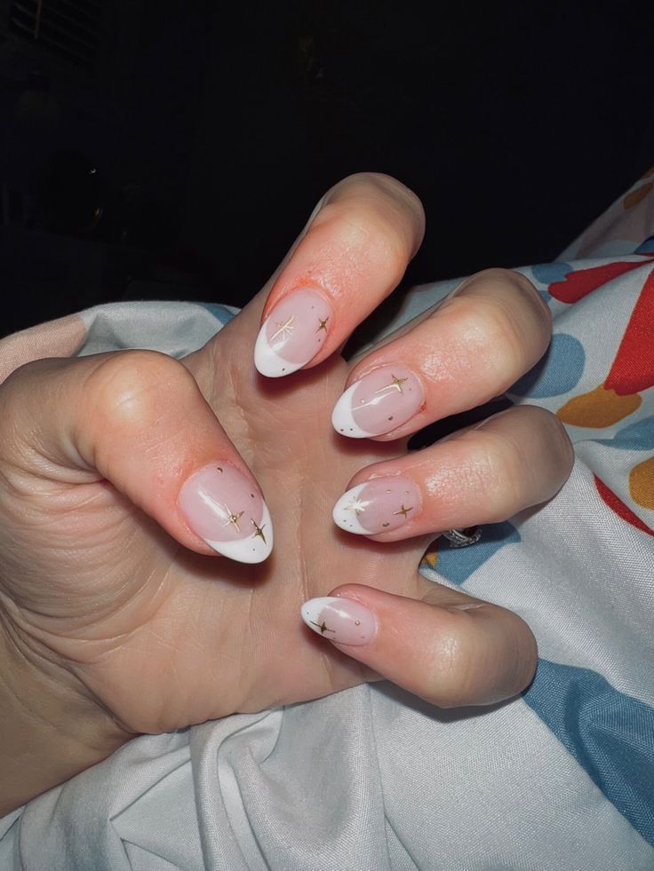 Photo of someone’s hand showing their nails with white French tips and gold sparkles drawn on every nail. Shorter French Tip Nails, Acrylic Nails White French Tip, White French Tip With Gold, French Tip Nails With Gold, French Tip Gold, French Tip With Gold, Gold Nails French, Sparkly French Tip Nails, Nails White French Tip