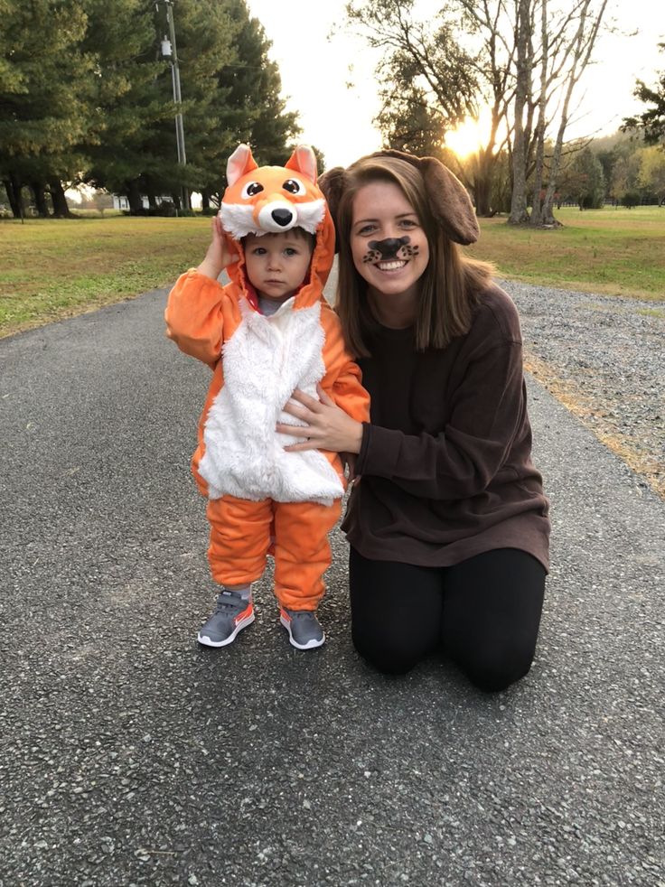 a woman and her child dressed up in animal onesuits, posing for the camera