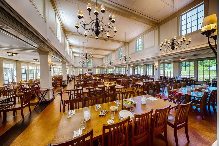 an empty dining room with tables and chairs