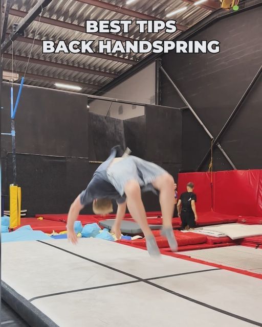 a man is doing tricks on a trampoline