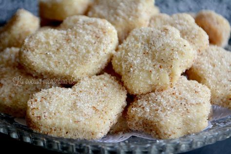 some sugar cookies are in a glass bowl