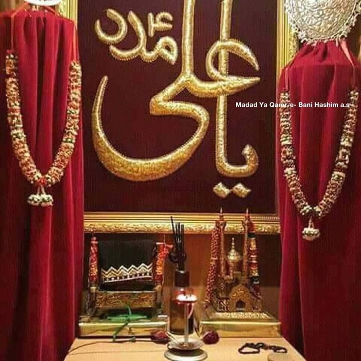 the arabic calligraphy is displayed in front of red drapes with gold trimmings