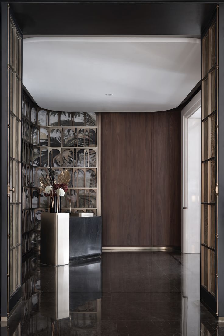 an entry way with glass blocks and vases on the floor in front of it